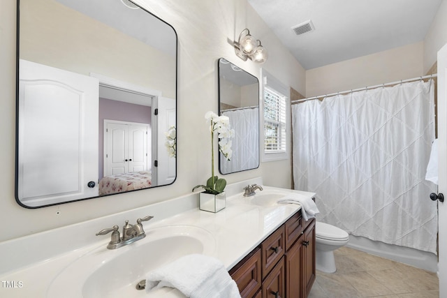 full bathroom with double vanity, visible vents, toilet, a sink, and tile patterned floors