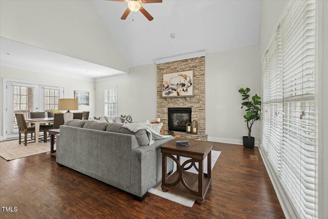 living area with dark wood-style floors, high vaulted ceiling, and a fireplace