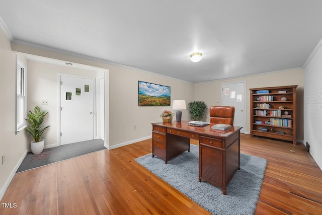 home office with baseboards, light wood-style flooring, and crown molding