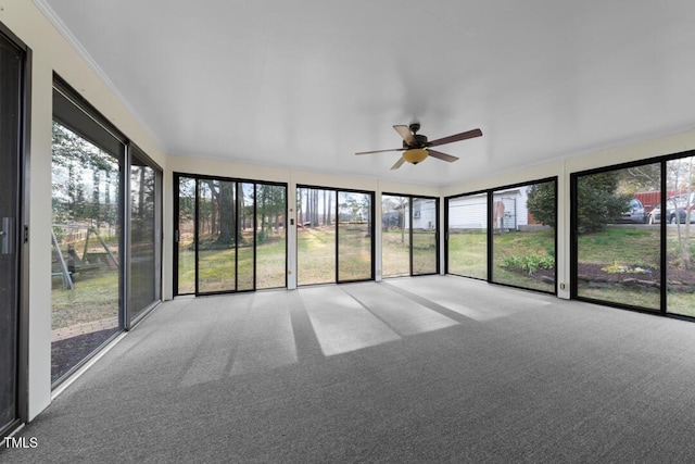 unfurnished sunroom featuring ceiling fan