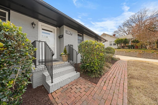 doorway to property with brick siding