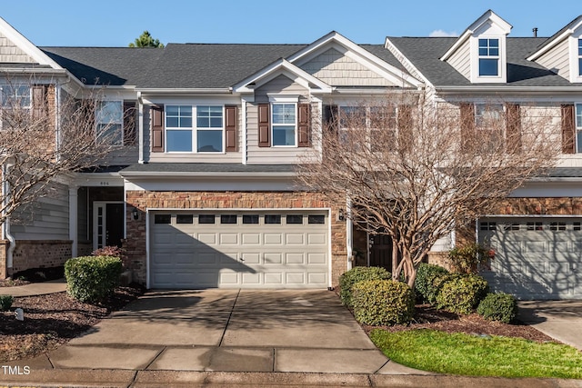 view of front of home featuring a garage, roof with shingles, concrete driveway, and brick siding