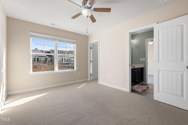 unfurnished bedroom featuring carpet, visible vents, a ceiling fan, connected bathroom, and baseboards