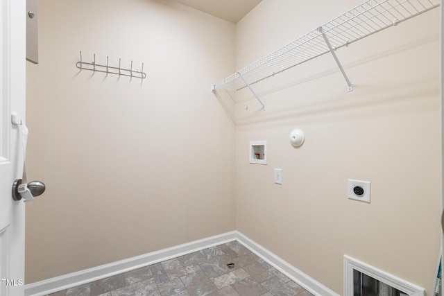 laundry area featuring laundry area, washer hookup, baseboards, stone finish floor, and electric dryer hookup