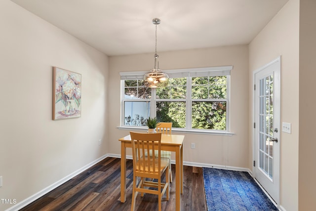 dining area with dark wood-style floors and baseboards