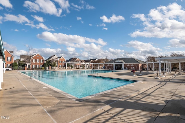 pool with a residential view, a pergola, and a patio