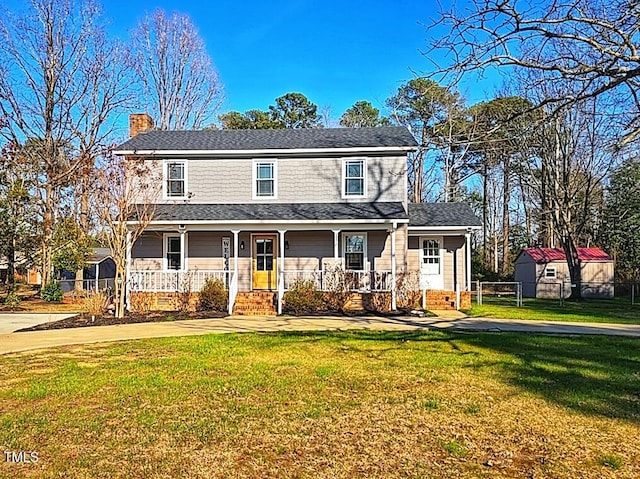 view of front of property with a chimney, roof with shingles, covered porch, fence, and a front yard