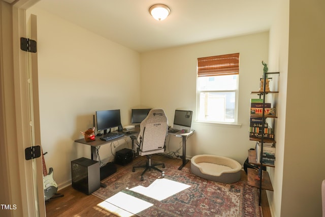 office space featuring baseboards and wood finished floors