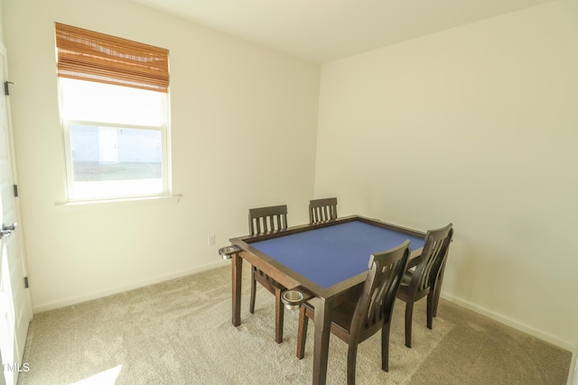 dining room with light carpet and baseboards