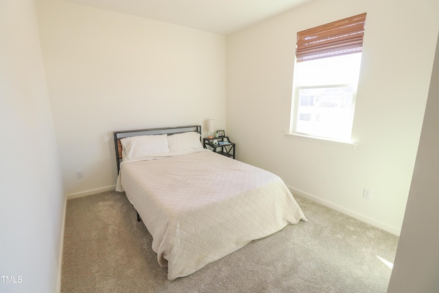 carpeted bedroom with baseboards