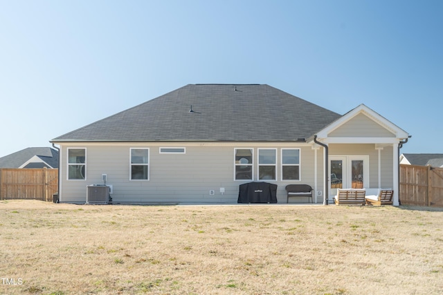 back of house with a yard, fence, and central air condition unit