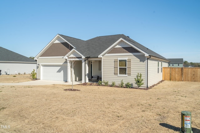 view of front of house with a garage, driveway, and fence