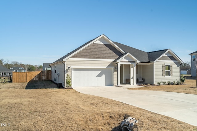 view of front of house with fence, driveway, and an attached garage