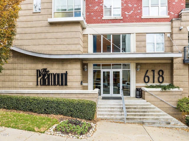 property entrance with french doors and brick siding