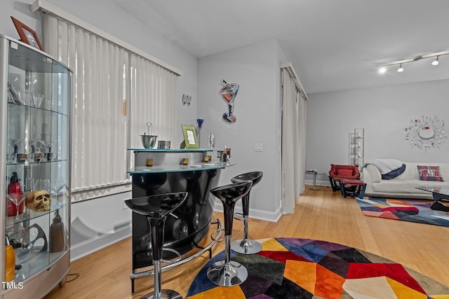 rec room featuring baseboards and wood finished floors