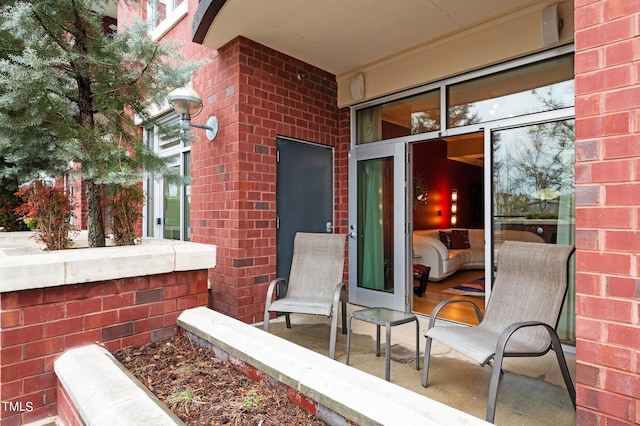 doorway to property featuring brick siding