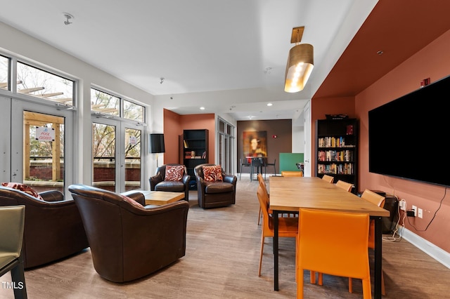 interior space featuring light wood finished floors, recessed lighting, baseboards, and french doors