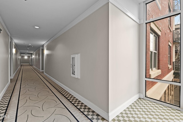 corridor with baseboards, crown molding, and recessed lighting