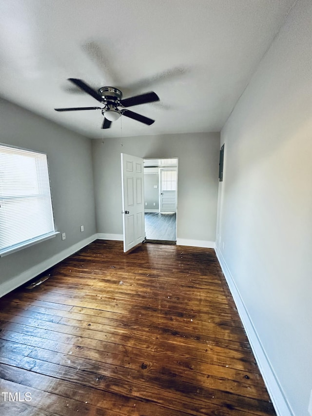 unfurnished bedroom featuring wood-type flooring, baseboards, ceiling fan, and a textured ceiling