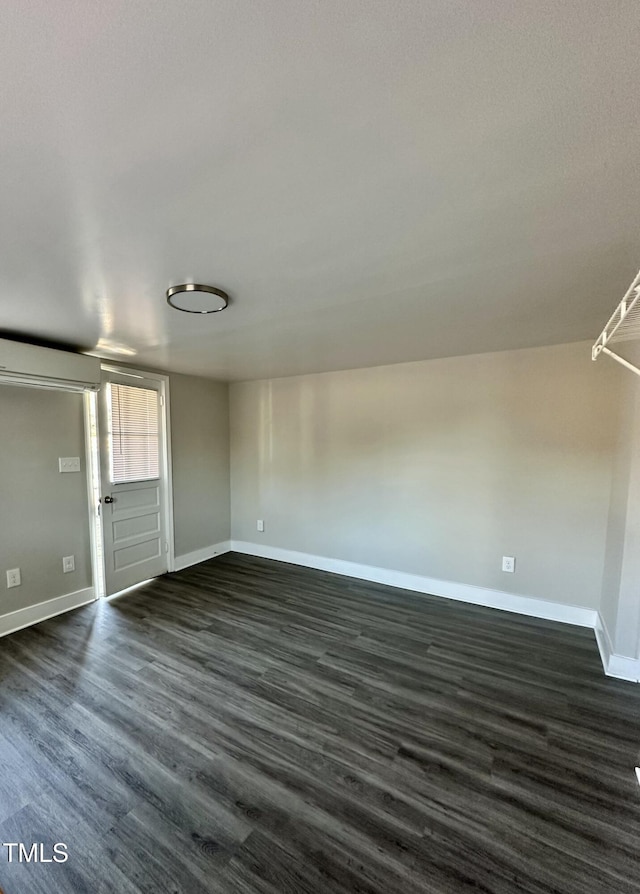 interior space with dark wood-style flooring and baseboards