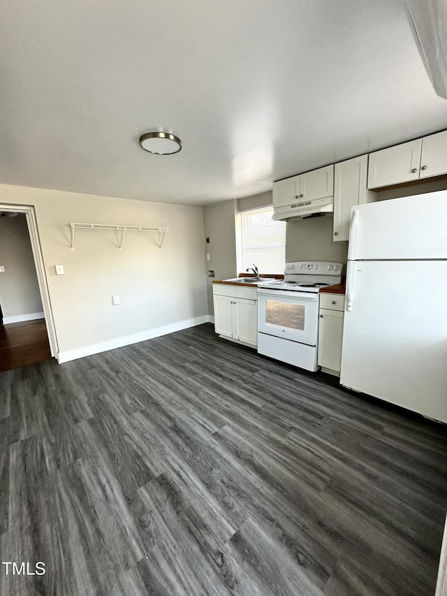 kitchen with white appliances, white cabinets, under cabinet range hood, and dark wood-style flooring