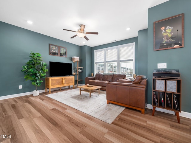 living area with recessed lighting, ceiling fan, baseboards, and wood finished floors