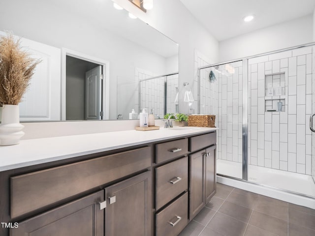 full bath featuring a stall shower, recessed lighting, vanity, and tile patterned floors