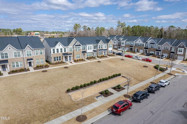 birds eye view of property with a residential view