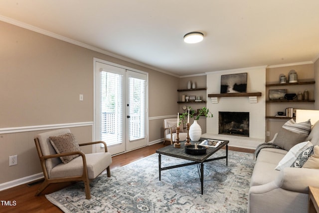 living area with ornamental molding, french doors, wood finished floors, and visible vents