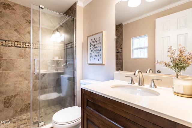 bathroom with toilet, a shower stall, ornamental molding, and vanity