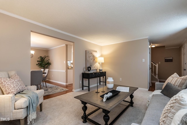 living room featuring carpet floors, a textured ceiling, stairway, and crown molding