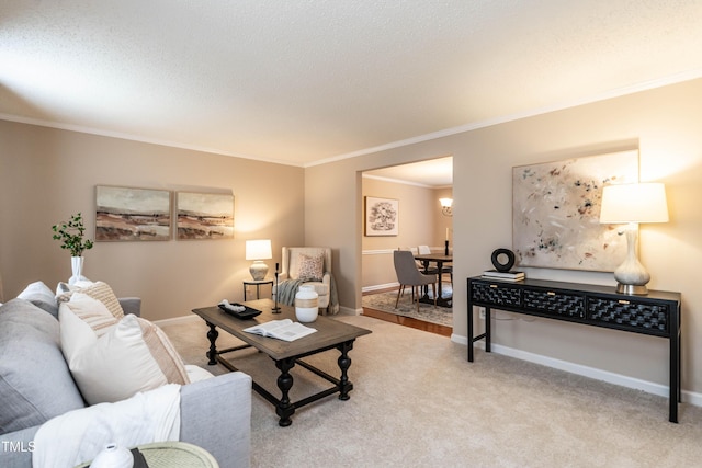 living room featuring light carpet, crown molding, baseboards, and a textured ceiling