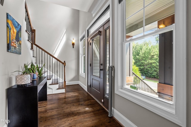 entrance foyer featuring baseboards, stairway, and dark wood finished floors