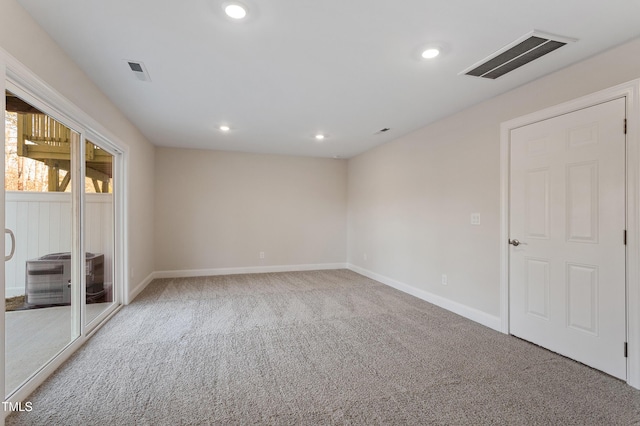 carpeted empty room featuring recessed lighting, visible vents, and baseboards