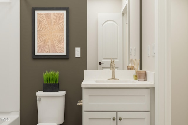 bathroom featuring toilet and vanity