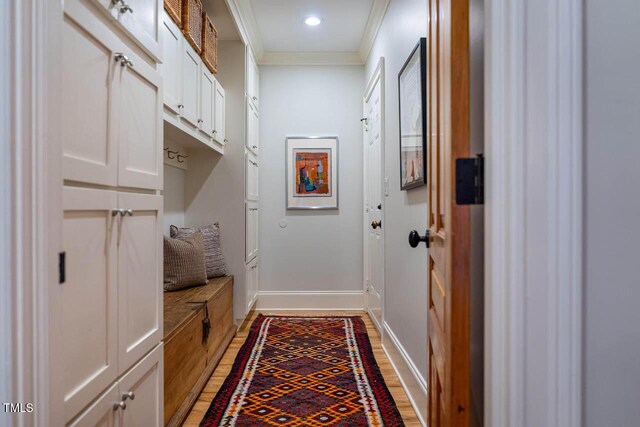 mudroom with light wood finished floors, recessed lighting, crown molding, and baseboards