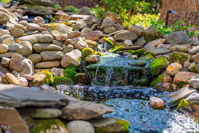 exterior space with a garden pond