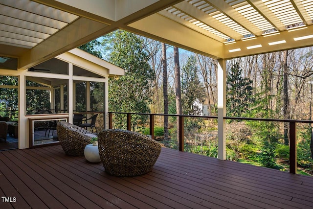 deck with a pergola and a sunroom