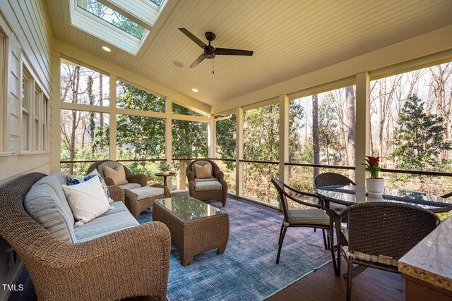 sunroom with lofted ceiling with skylight and a healthy amount of sunlight