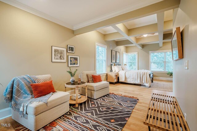 bedroom featuring baseboards, coffered ceiling, beam ceiling, and wood finished floors