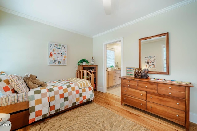 bedroom featuring ceiling fan, ensuite bathroom, light wood-style flooring, and crown molding