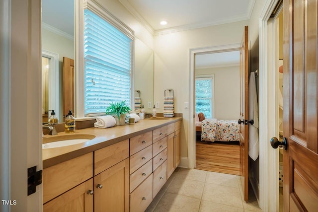 ensuite bathroom with double vanity, ornamental molding, ensuite bathroom, tile patterned floors, and a sink