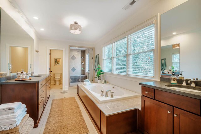 full bathroom featuring visible vents, a garden tub, ornamental molding, a stall shower, and a sink