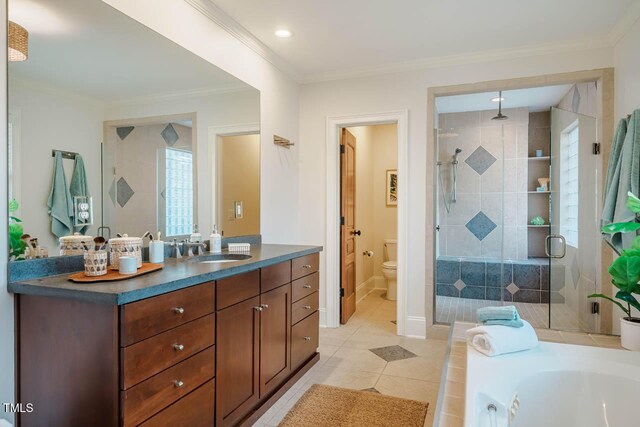 bathroom with tile patterned flooring, crown molding, toilet, a stall shower, and vanity