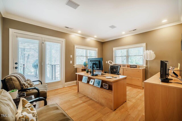 office with visible vents, light wood-style flooring, and crown molding