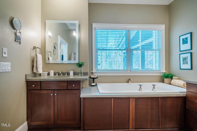 full bath featuring plenty of natural light, vanity, and a garden tub