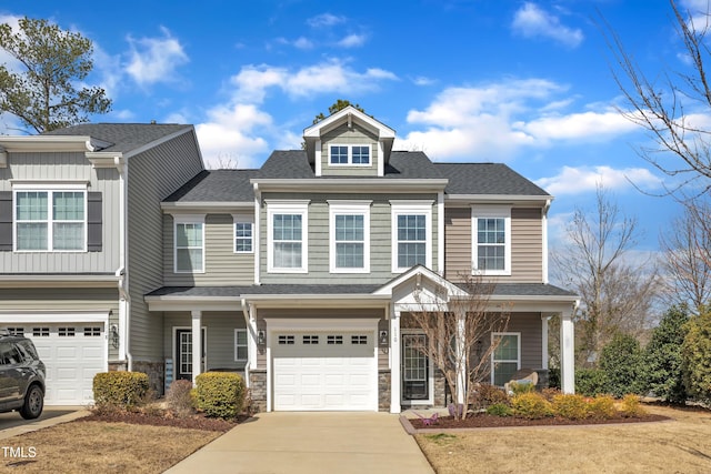 view of front of home with driveway, stone siding, roof with shingles, and an attached garage