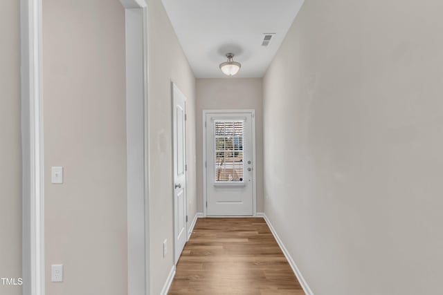 entryway with visible vents, baseboards, and wood finished floors