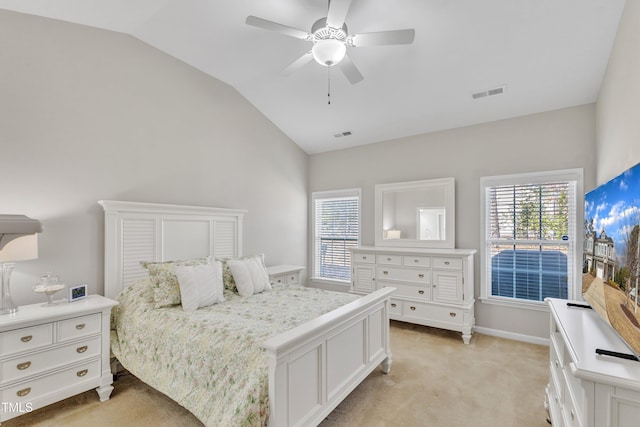 bedroom featuring lofted ceiling, multiple windows, visible vents, and light carpet