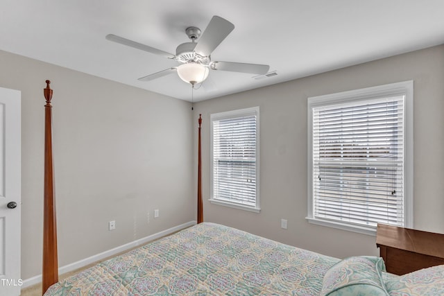 bedroom featuring a ceiling fan, visible vents, and baseboards